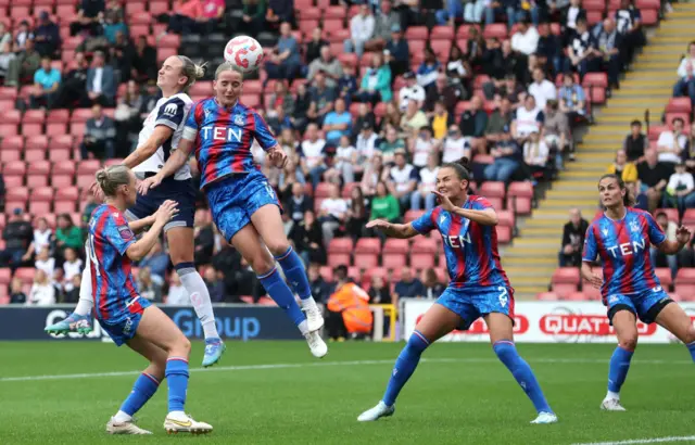 Thomas rises highest in the box to head a chance at goal