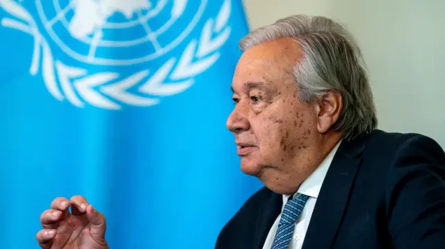 UN Secretary-General Antonio Guterres in front of UN flag