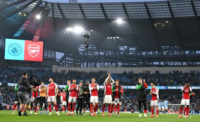 Arsenal players applaud their fans