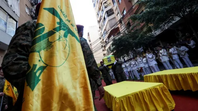 Pallbearers carry the coffin of Hezbollah commander Ibrahim Aqil while a brass band plays