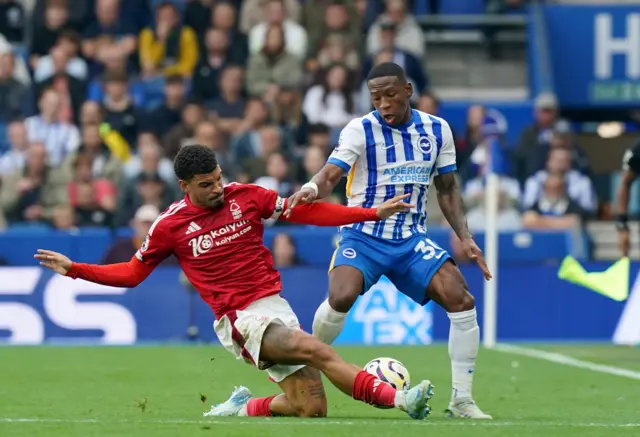 Gibbs-White and Estupinan compete for the ball