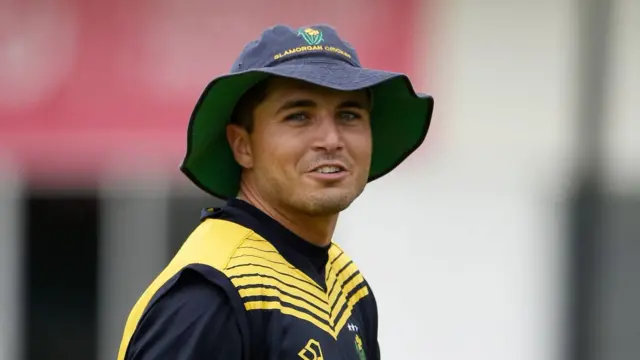 Kiran Carlson of Glamorgan in training kit and a floppy hat