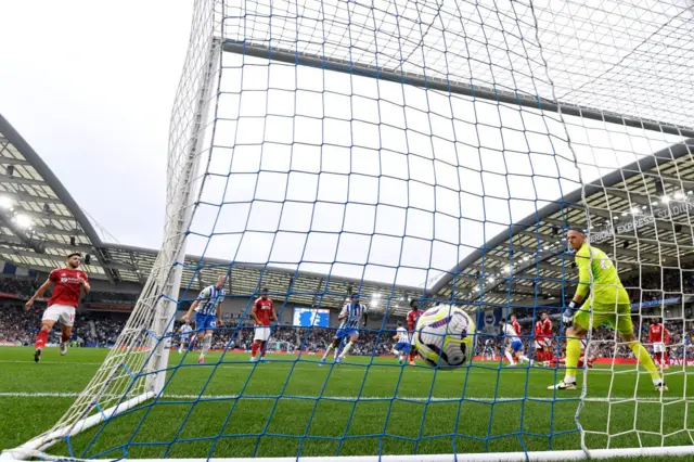 The ball hitting the back of the net for the second goal, as shown through the goal