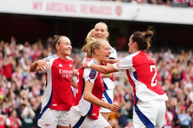 Maanum is mobbed by teammates after opening the scoring