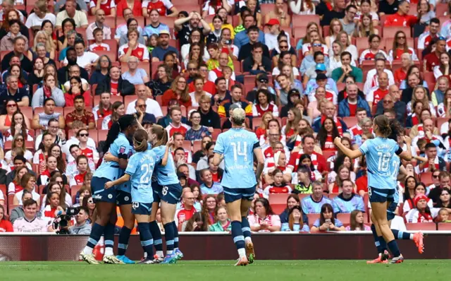 Man City players mob Viv Miedema after her equaliser at Arsenal