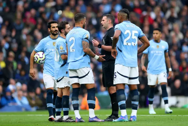 City players surround the referee