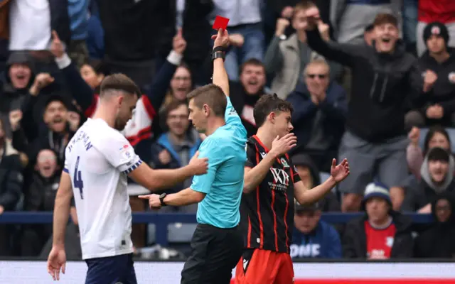 A red card is shown to Owen Beck