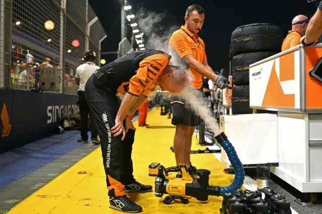 McLaren team member cools off before the Singapore Grand Prix