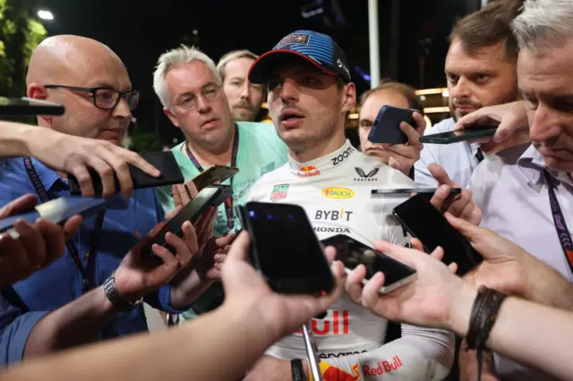 Journalists surround Max Verstappen after qualifying in Singapore