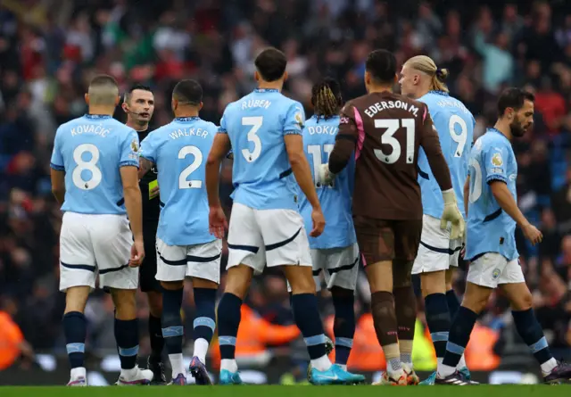 City players surround referee Michael Oliver