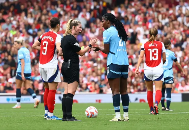 Shaw talks to the ref after being booked