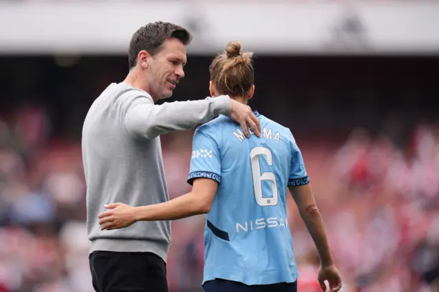 Taylor congratulates Miedema with a hug