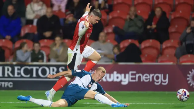 Fleetwood goalscorer Ryan Graydon battles with Morecambe's Ross Millen.