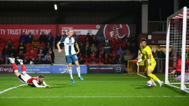 Ryan Graydon heads Fleetwood into the lead against Morecambe.