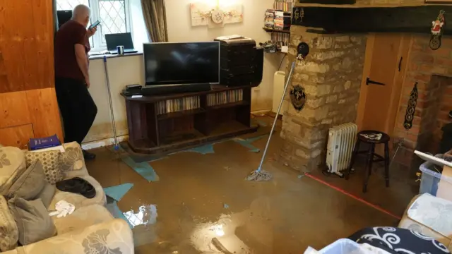 Tim Maher in his flooded house in Grendon, Northamptonshire