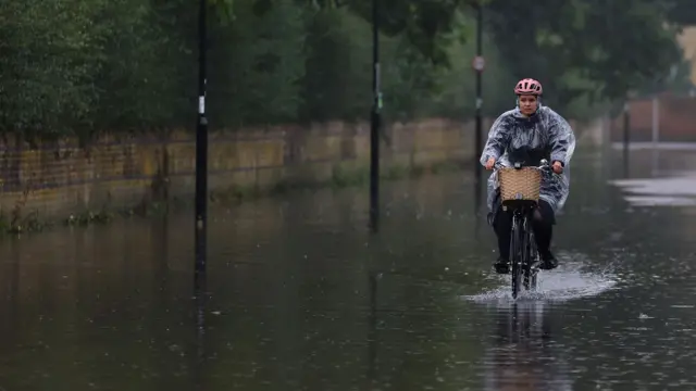 Heavy rain combined with the rising level of the River Thames over spilled onto roads in West London