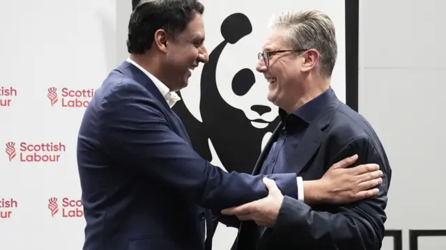 Scottish Labour leader Anas Sarwar and Prime Minister Keir Starmer embrace at a conference event