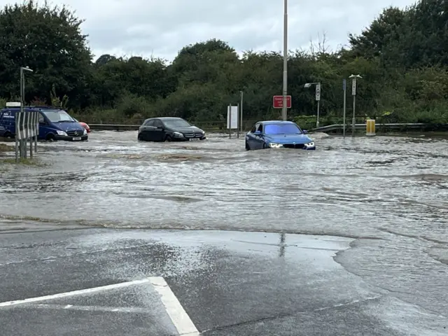 Cars and vans have become stranded in flood water at junction nine of the M1.