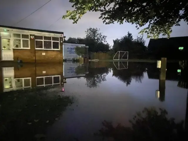 Flood water covers the area directly in front of a primary school.