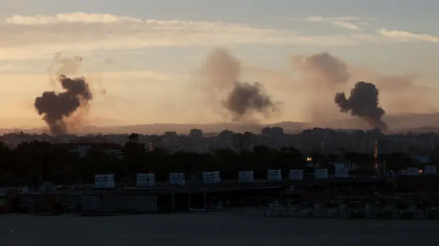 Smoke rising over buildings