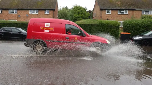 A Royal Mail vehicle drives through a flooded road in Harpenden, England. Photo: 23 September 2024