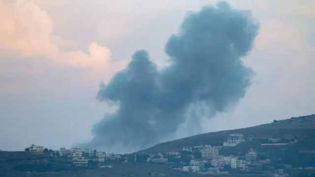 Smoke billows above a village near Marjayoun