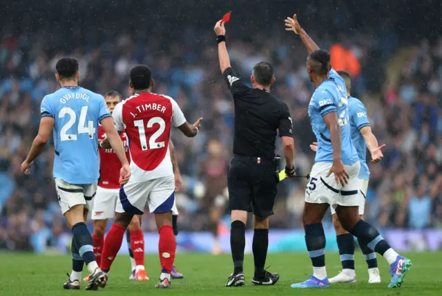 Leandro Trossard is shown a red card