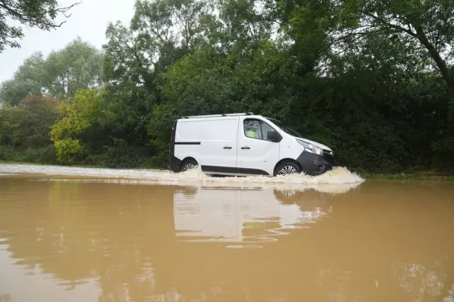 A white van driving in flood water on Hardwater Road near Wellingborough