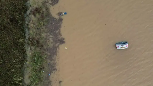 In Marston Moretaine, Bedfordshire, only the open boot of a submerged car is visible on A421. Photo: 23 September 2024