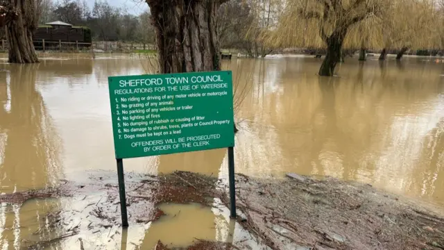 Flood water around a Shefford Town Council sign.