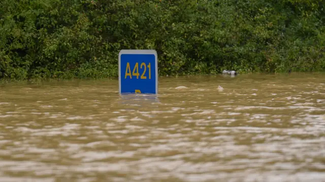 A road sign submerged in flood water on the A421 in Marston Moretaine, Bedfordshir