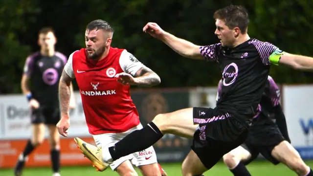 Larne's Andy Ryan in action against Loughgall's Ben Murdock