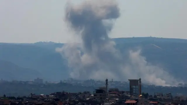 Smoke rising in the aftermath of a strike is pictured from the city of Tyre, southern Lebanon