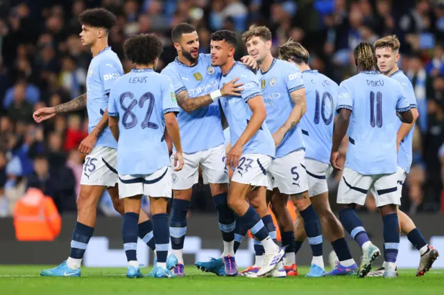 Matheus Nunes is surrounded by his team-mates after scoring for Manchester City in the EFL Cup against Watford