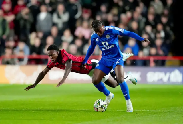 Leicester City's Abdul Fatawu (right) tackles Walsall's Liam Gordon