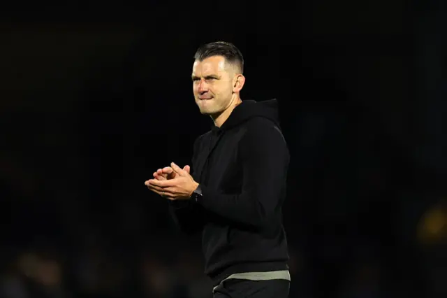 Wycombe Wanderers manager Matt Bloomfield applauds the home fans after his side's EFL Cup defeat at home to Aston Villa