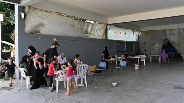 Families in a makeshift school shelter