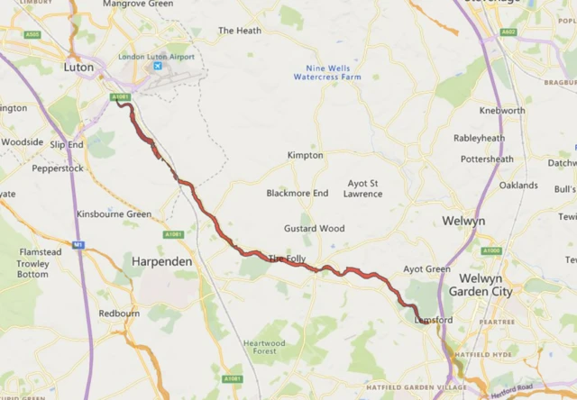 A photo of a map shows a red flood warning along the River Lee between Luton and Welwyn Garden City. It shows a large area of Hertfordshire where the river stretches and it details the flood warning in red.