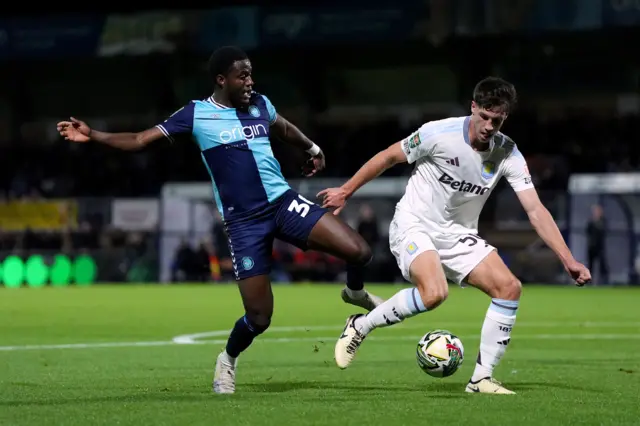 Wycombe Wanderers’ Beryly Lubala battle for the ball with Aston Villa's Sil Swinkels