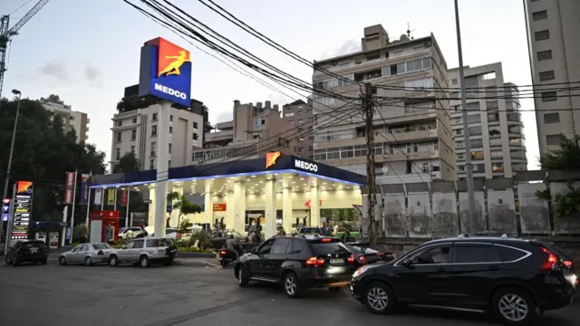 Vehicles queue to get fuel at a gas station in Beirut