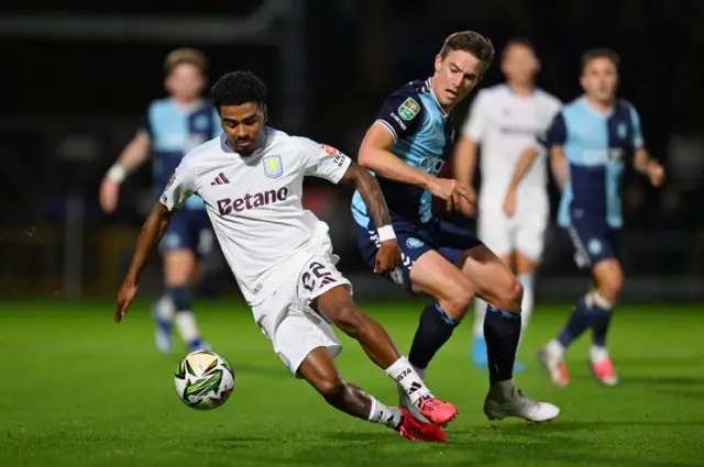 David Wheeler chases Ian Maatsen in Wycombe Wanderers' EFL Cup tie against Aston Villa