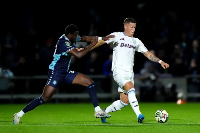 Aston Villa's Ross Barkley, (right) battle for the ball with Wycombe Wanderers’ Beryly Lubala