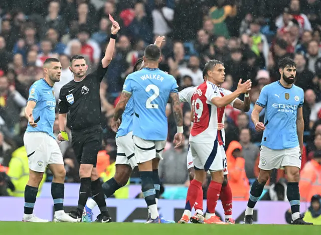 Leandro Trossard of Arsenal is shown a red card by referee Michael Oliver