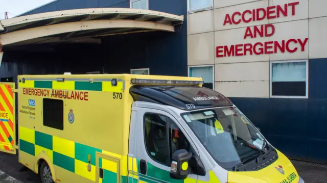 An ambulance is parked outside the entrance to Luton & Dunstable Hospital which says "Accident and Emergency"