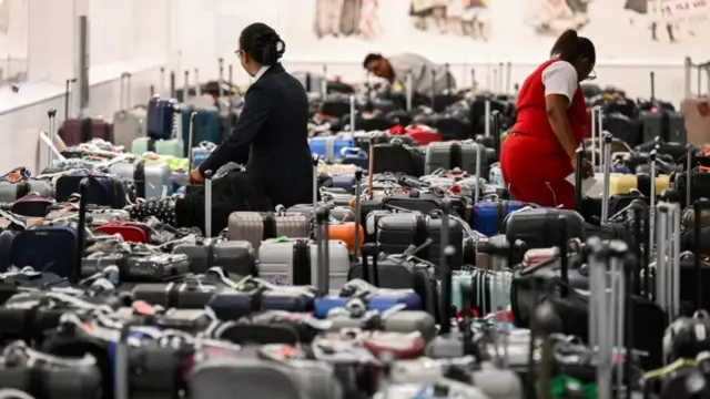 Delta Airlines staff search through passenger luggage at Los Angeles International Airport on 24 July