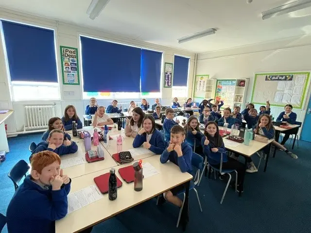 A picture of P6 Class at Trinity Primary School with their thumbs up ready to start the Live Lesson