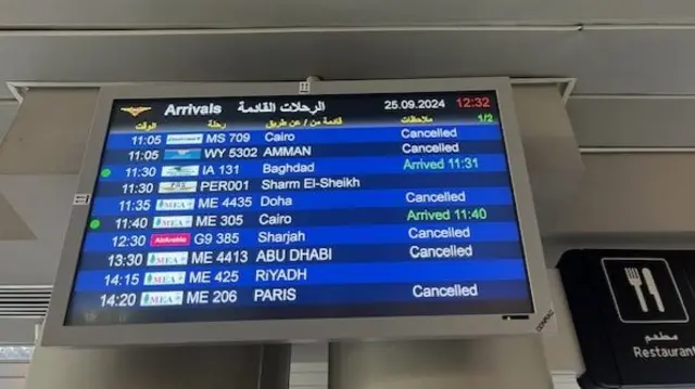 Beirut Airport's arrivals display shows many flights have been cancelled on Wednesday