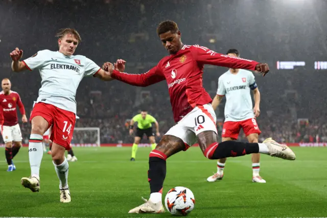 Marcus Rashford (R) vies for the ball with  Sem Steijn