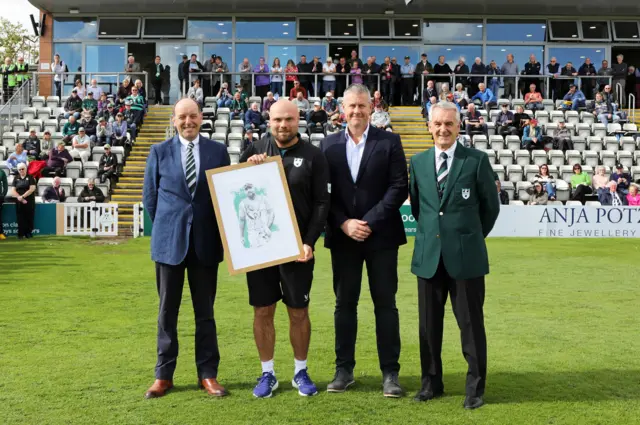 Joe Leach is presented with a framed caricature marking his 13 seasons with Worcestershire by (from left) club chairman Dominic Riley, chief executive Ashley Giles and club president Phil Neale