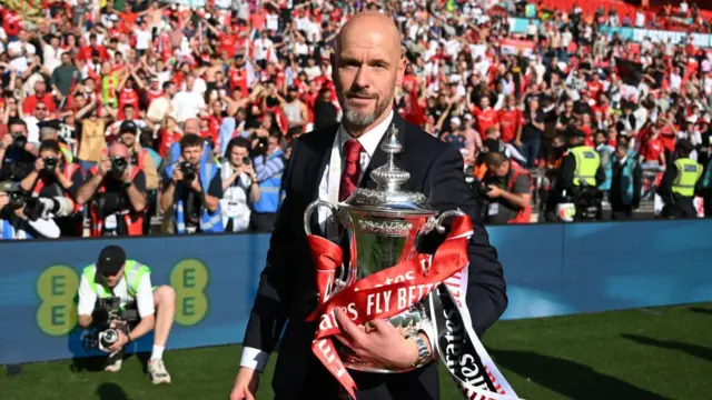 Erik ten Hag, manager of Manchester United looks on with the FA Cup trophy after the Emirates FA Cup Final match between Manchester City and Manchester United at Wembley Stadium on May 25, 2024 in London, England.